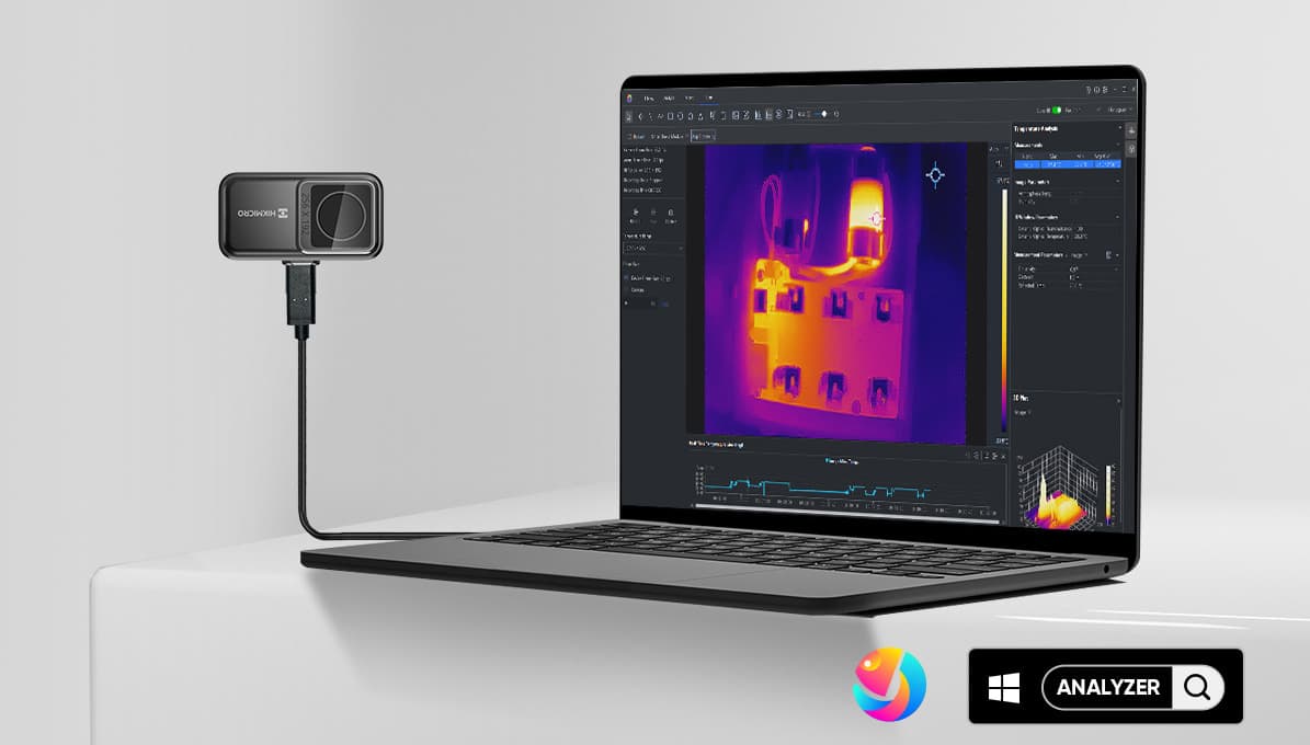 En bärbar dator visar en termisk bild på skärmen, ansluten till en extern kamera för värmeanalys.